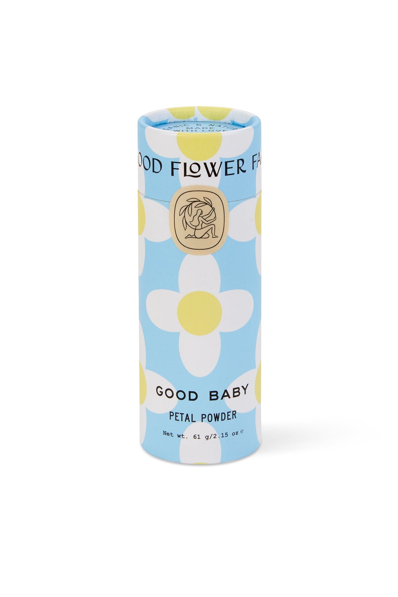A cylindrical Good Flower Farm Good Baby Gift Set container sits on a blue background with white, yellow-centered flowers. Its label displays a gold emblem and black text, highlighting gentle botanical ingredients.